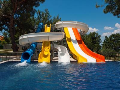 Kolorowe zjeżdżalnie do basenu pod słonecznym niebem.