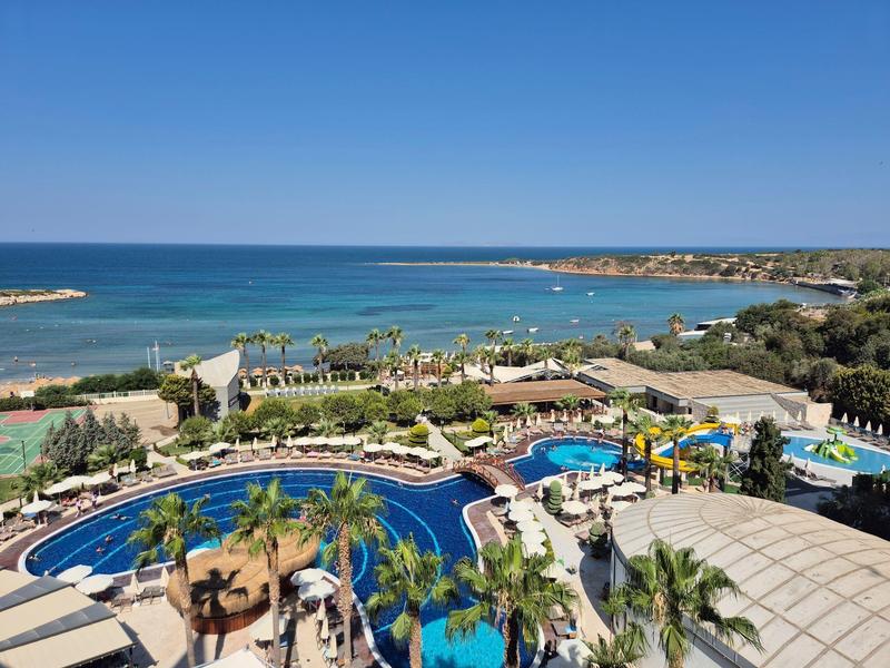 Widok z lotu ptaka na nadmorski kurort z basenami i morzem na tle czystego nieba.