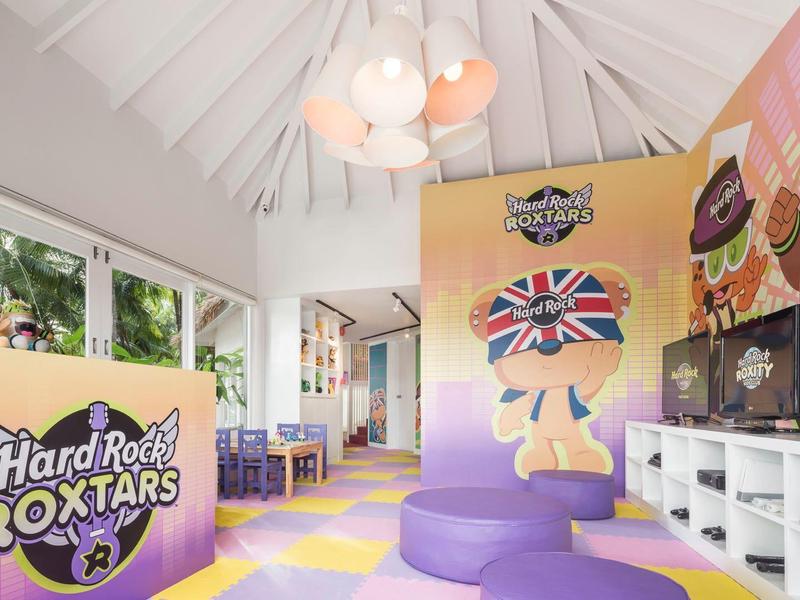 Moderner Indoor-Spielplatz mit weichen Kletterelementen, buntem Boden und großen Fenstern.