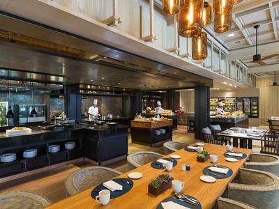 Elegant restaurant with wooden tables, set plates, and modern black and white design.