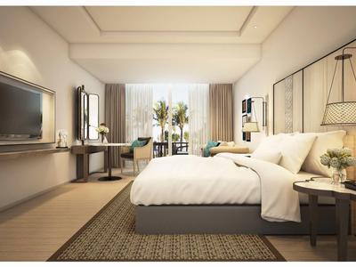 Modern bright hotel room with large bed, TV, desk, and stylish decor.