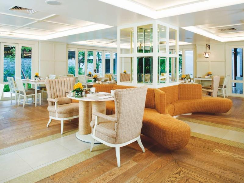 Bright modern restaurant with cozy seating and large windows.