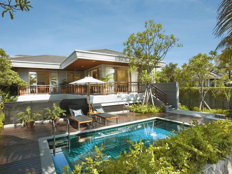 Modern bungalow with terrace and small pool in a green garden.