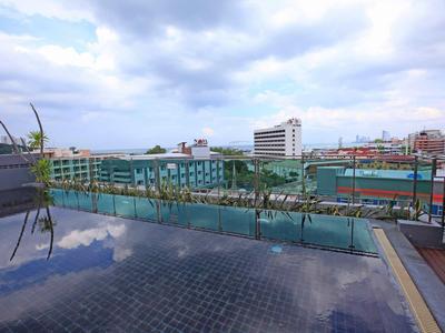 Dakterras met zwembad en uitzicht op stadsgebouwen bij bewolkte lucht