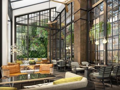 Helles Café mit großen Fenstern, Pflanzenwand, gemütlichen Sofas und modernen Stühlen.