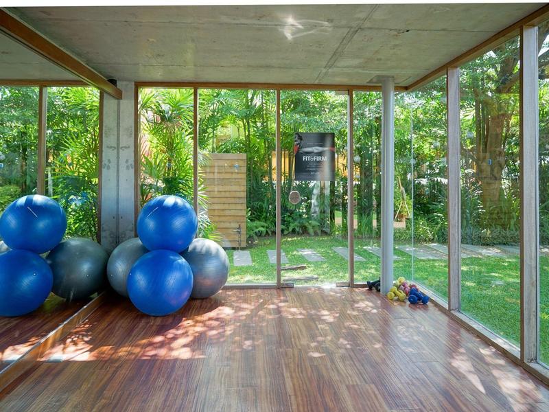 Jasná fitness místnost s velkými okny a modrými gymnastickými míči.