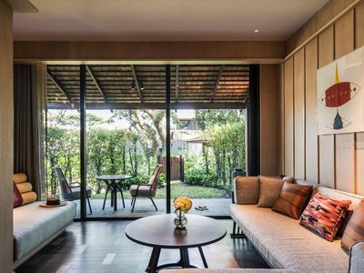 Modern living room with large windows overlooking a garden with a terrace.