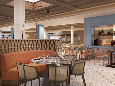 Área de comedor de hotel moderna con mesas preparadas, sillas cómodas y tonos cálidos.