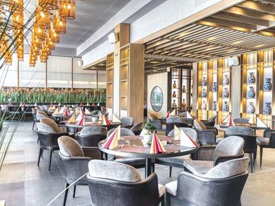 Elegant hotel restaurant with modern decor and cozy seating areas.