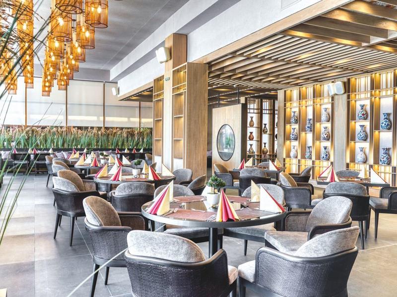 Elegant hotel restaurant with modern decor and cozy seating areas.