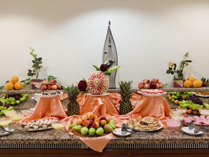 Elegant buffet with fruits and decorative elements in a hotel restaurant.