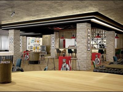 Acogedor bar de hotel con decoración de Guinness y pósters de música vintage en las paredes.