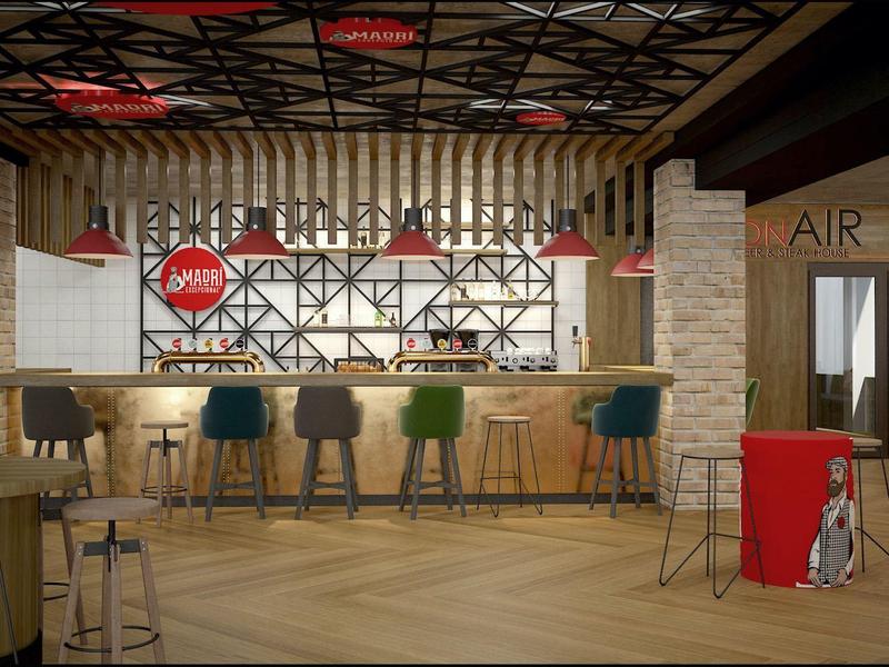 Bar moderno con sillas variadas y decoración cálida en un espacio acogedor de hotel.