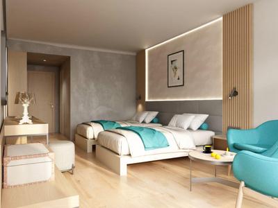 Modernes Hotelzimmer mit zwei Betten, blauen Akzenten und gemütlichem Sitzbereich.