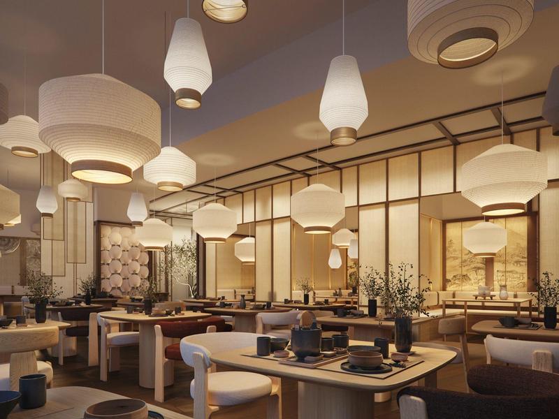 Interior moderno de restaurante con iluminación cálida y lámparas colgantes elegantes.