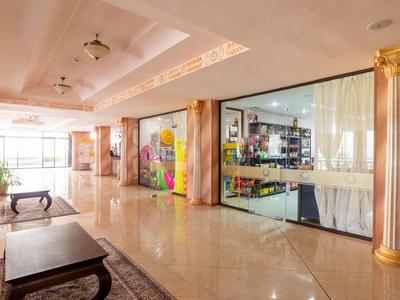 Spacious, elegant hotel hallway with marble floor and ornate columns.