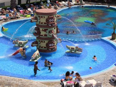 Children's wading pool with water play equipment and ping pong table in a round pool