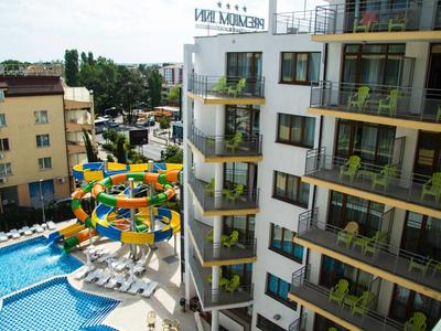 Meerkamerhotel met balkons met uitzicht op kleurrijke glijbanen en zwembad.