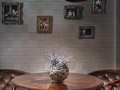 Gezellige ronde houten tafel met vaas en lavendel, omringd door leren stoelen in een elegant vertrek.