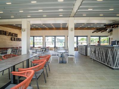 Ruime, moderne restaurantinterieur met stoelen en tafels, helder en luchtig.