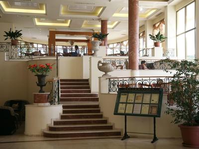 Elegante hotel lobby met trap, planten en verlichting