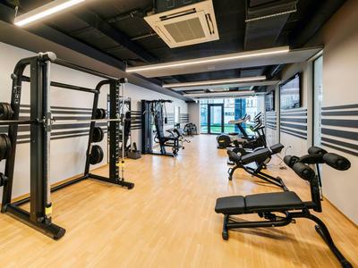 Gimnasio moderno con equipo y pesas en un hotel.