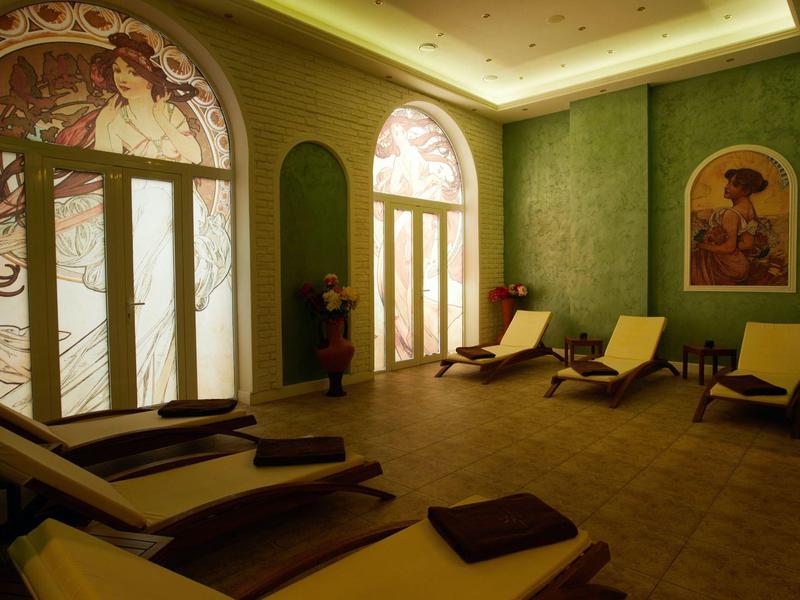 Cozy wellness room with lounge chairs, soft lighting, and wall art.