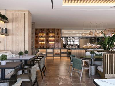 Modern hotel restaurant with wooden furniture, plants, and stylish lighting.