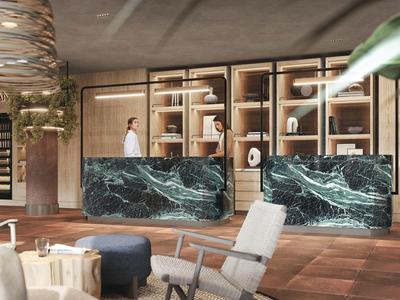 Modern hotel check-in area with green marble counters and wooden bookshelves in the background