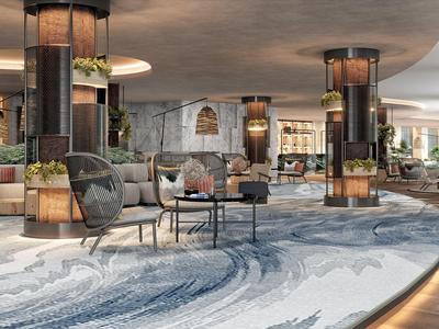 Modernes, offenes Hotellobby mit stilvollen Sitzbereichen und beleuchteten Säulen.