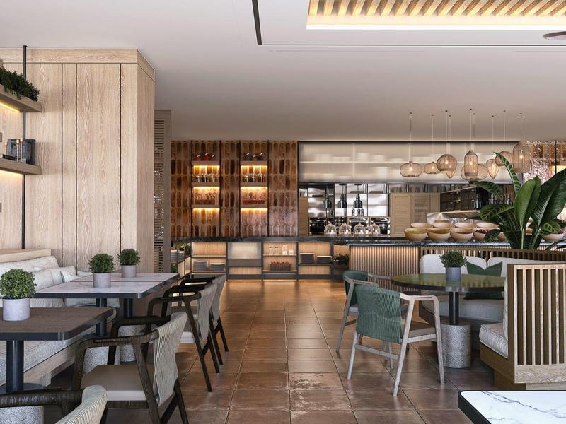 Modern hotel restaurant with wooden furniture, plants, and stylish lighting.
