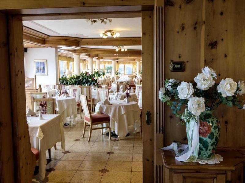 Blick durch Tür zu stilvollem Speisesaal mit gedeckten Tischen und Blumendekoration.