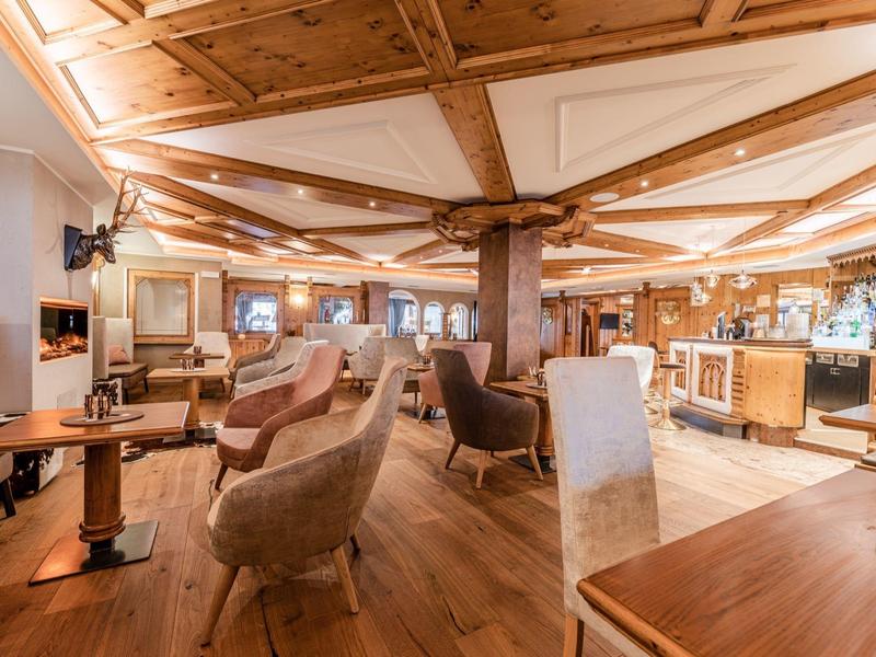 Accogliente area bar dell'hotel con mobili in legno e luce calda.