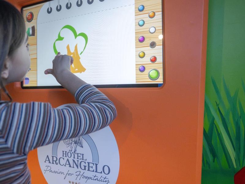 Personne interagissant avec un écran de dessin numérique dans un cadre hôtelier.