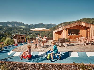 Wooden pool with sun terrace and mountain view under clear sky