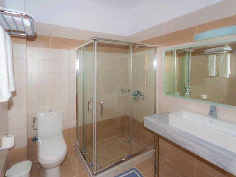 Bagno moderno con doccia in vetro, WC e lavabo con grande specchio