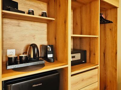 Küchenschrank mit Kaffeemaschine, Toaster, Wasserkocher und schwarzem Mini-Kühlschrank.