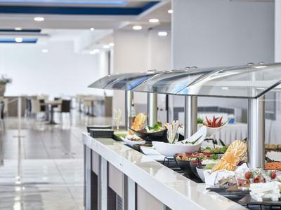 Buffet area in a bright restaurant with various dishes on the counter