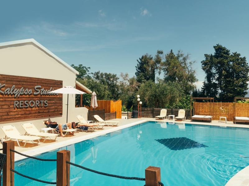 Piscine dégagée avec chaises longues et clôture en bois par temps ensoleillé au resort