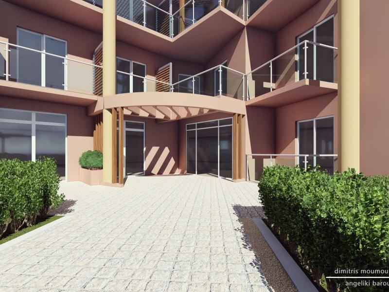 Ingresso di un hotel moderno con sentiero lastricato e siepi su entrambi i lati.