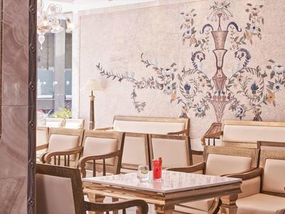 Gemütlicher Sitzbereich mit beige gepolsterten Sesseln und dekorativer Wand im Hotel.