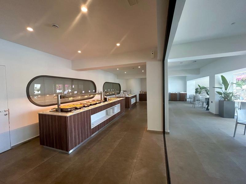 Modern buffet with a warm ambiance in a spacious, bright restaurant area.