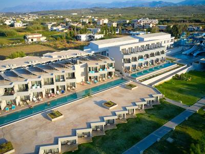 Modernes Resort mit Pool im Freien und Blick auf grüne Landschaft und Berge.