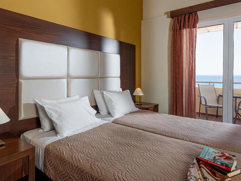 Hotel room with two single beds and sea view through the window