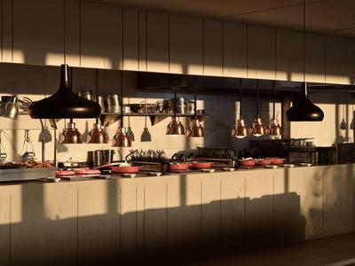 Cuisine moderne avec ustensiles et suspensions sous une lumière chaude.