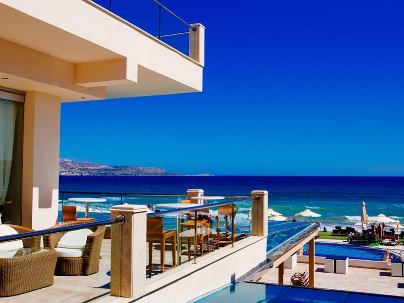 Hotelová terasa s posezením s výhledem na modrý oceán a slunečnou oblohu