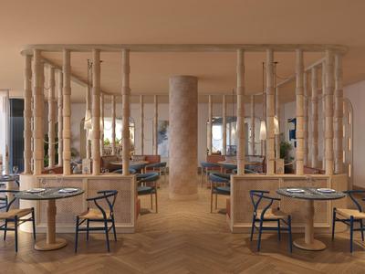 Restaurante moderno con suelo de madera, mesas redondas y grandes ventanas con vista al mar.