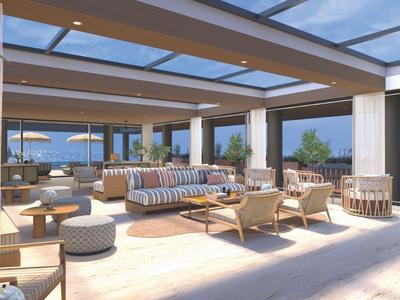 Geräumige Lounge mit bequemen Sitzmöbeln und Panoramablick auf das Meer.