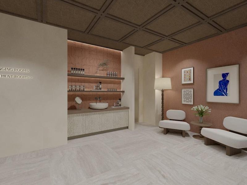 Moderní hotelová mycí oblast s umyvadly a útulným sezením s uměleckými díly na stěnách.