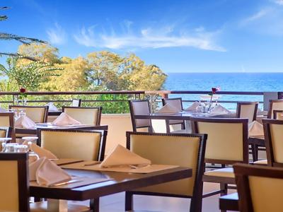 Open dining area with sea view and set tables.